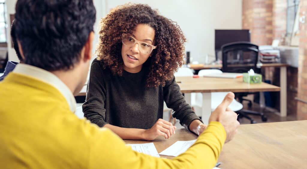 Three professional sitting at a table in what appears to be an interview