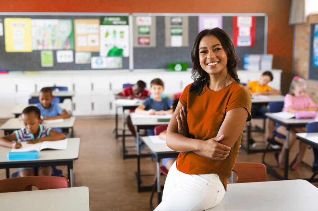 Female teacher smiling in an elementary school classroom