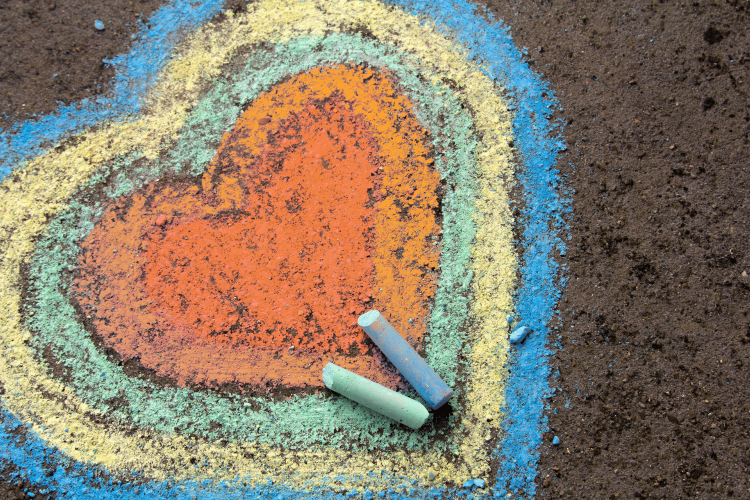 Heart drawn on sidewalk with chalk. KE education