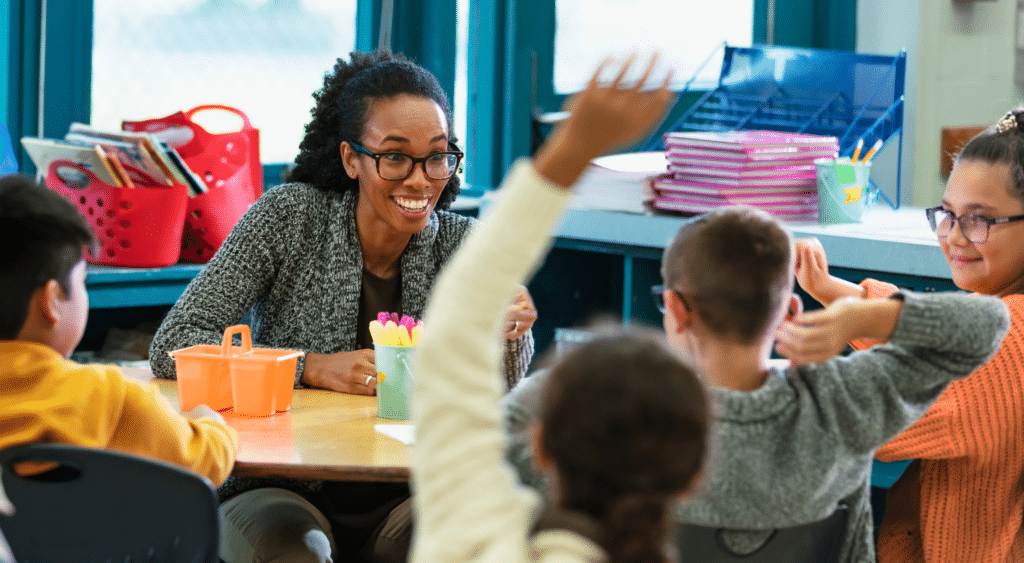 teacher talking with elementary students