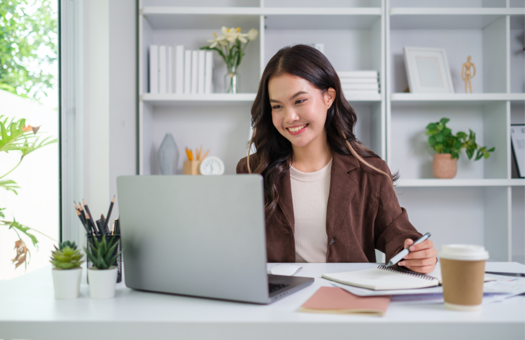 woman with laptop and notes